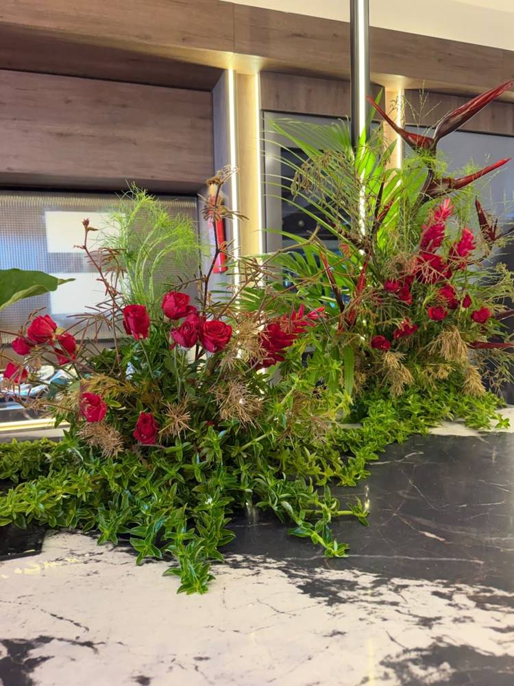Red roses and ginger spilling across a marble bar