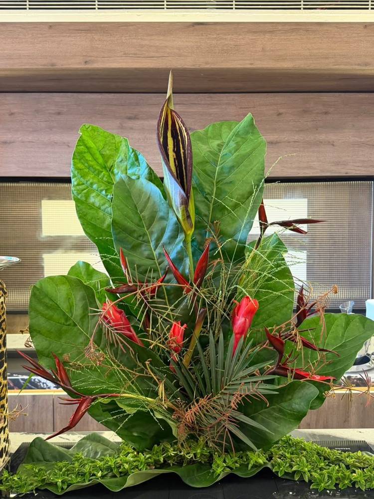A leaf and ginger sculpture with a striped spathe rising from the centre